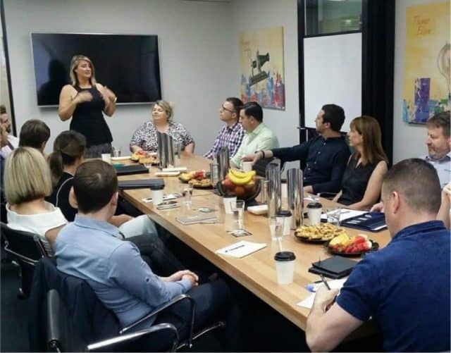 Boardroom filled with people hosting a branch meeting