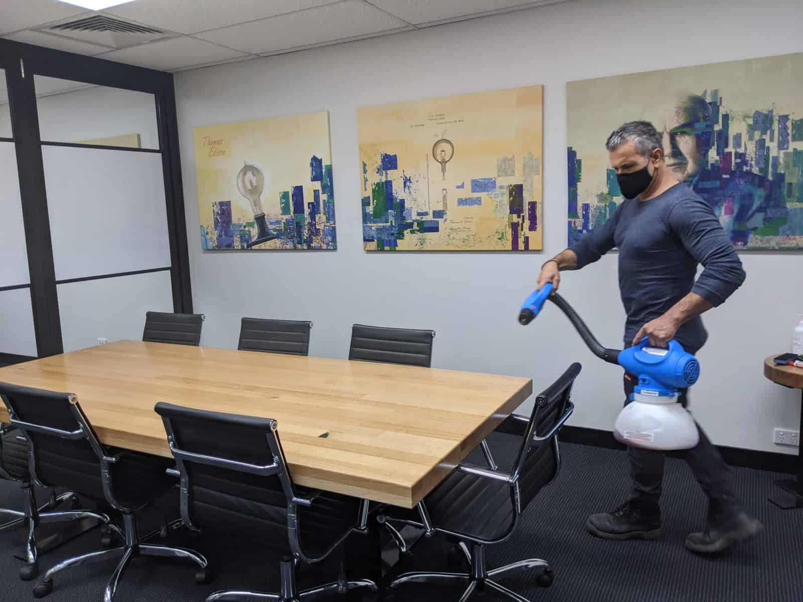 Man Sanitising A Virtual Office